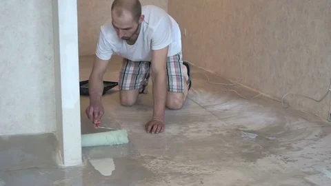 The worker prepares the floor for tiling Stock Footage 74055432