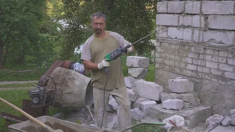 A worker prepares a mixture of cement. Hinders with a drill. Close-up. 스톡 동영상 113277164