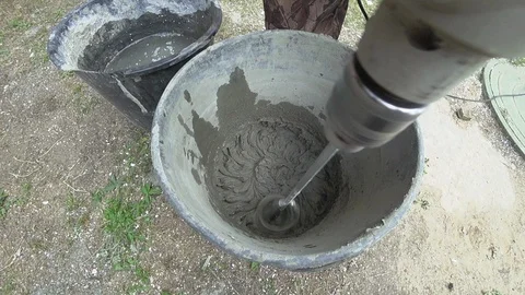 A worker prepares a mixture of glue, cement. Hinders with a drill. Slow motion. 스톡 동영상 94071329