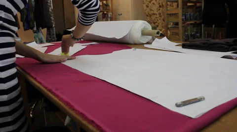 Worker prepares pattern for cutting fabric 1 Stock Footage 33312030