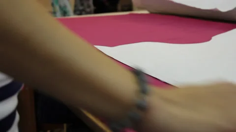 Worker prepares pattern for cutting fabric 2 Stock Footage 33312166