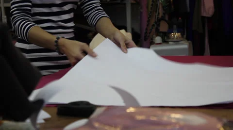 Worker prepares pattern for cutting fabric 3 Stock Footage 33312177