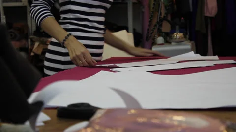 Worker prepares pattern for cutting fabric 4 Video stock 33312182