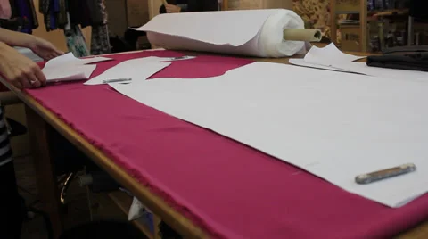 Worker prepares pattern for cutting fabric 7 Stock Footage 33312373
