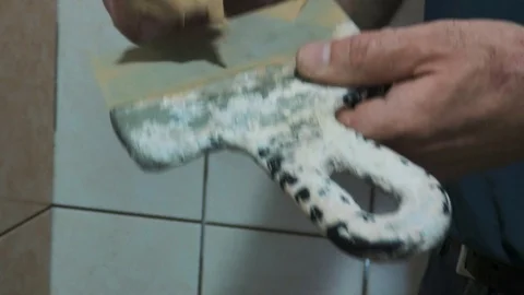 Worker prepares putty for tile Stock Footage 89580671