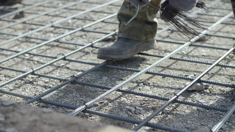 Worker prepares rebar wire for concrete reinforcement Stock Footage 310406748