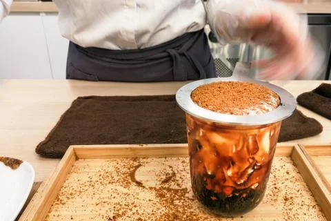 Worker preparing Boba or Bubble tea with caramel in shop Stock Photos