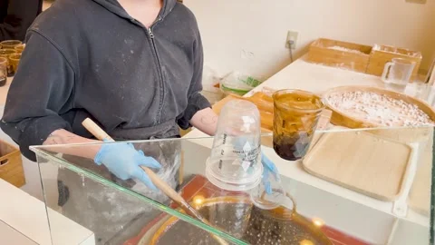 Worker Preparing Brown Sugar Bubble Tea in a Harajuku Boba Shop Stock Footage 331494301