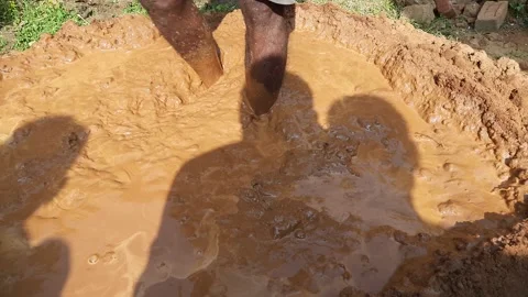 A worker is preparing a clay solution. Stock Footage 165793460