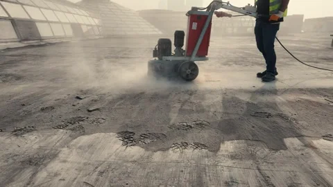 Worker Preparing Concrete Floor with Scraping Machine Stock Footage 320550577