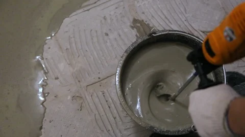 Worker preparing floor mortar Stock Footage 128409846