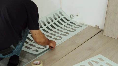 Worker Preparing Floor Underlayment for Laminate Installation Stock Footage 322055307