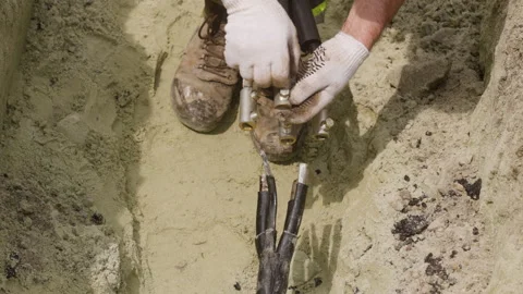 The worker is preparing a new cable for replacement on the power transmission Stock Footage 244640689