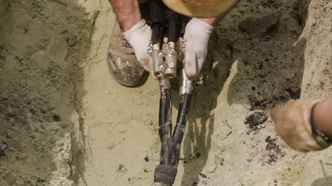 The worker is preparing a new cable for replacement on the power transmission Stock Footage 244640727