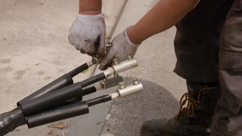 The worker is preparing a new cable for replacement on the power transmission Stock Footage 244641009