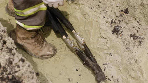 The worker is preparing a new cable for replacement on the power transmission Stock Footage 244641359