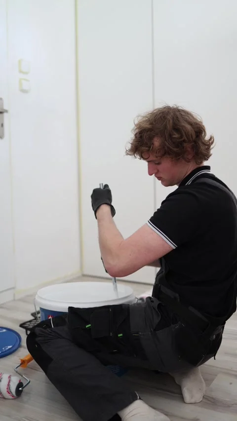 Worker preparing paint for renovation Video stock 334591960