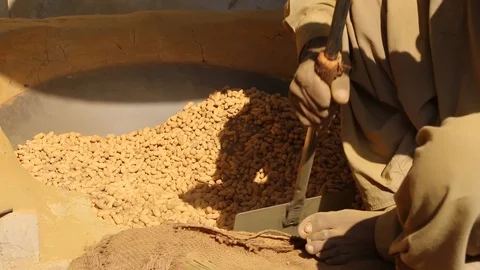 A Worker Preparing Peanuts in hot sand oven. Stock Footage 86657166