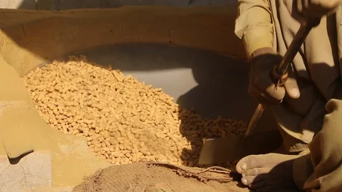 A Worker Preparing Peanuts in hot sand oven. Stock Footage 86657168