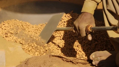 A Worker Preparing Peanuts in hot sand oven. Stock Footage 86657234