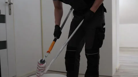 Worker preparing roller for painting 스톡 동영상 335040151