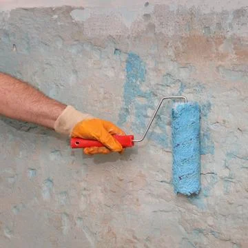 Worker preparing wall for tile gluing Stock Photos