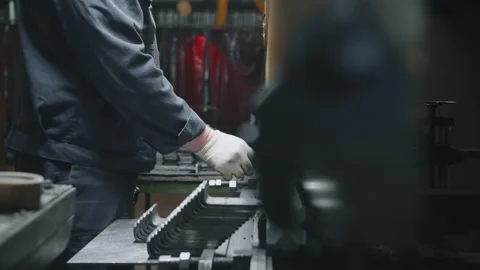 A worker on a press machine bends metal blanks Stock Footage 196185226