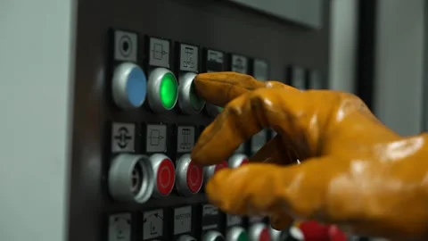 The worker presses the control buttons with a soiled gloved hand. Stock Footage 247697270