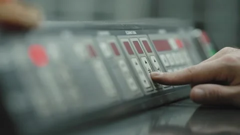 Worker pressing control panel buttons on industrial machine Stock Footage 331759131