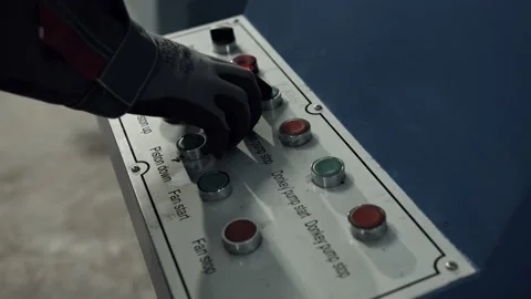 The worker pressing controls of the machine the buttons 6 Stock Footage 154713043