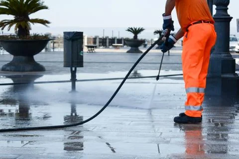 A worker with a pressure washer Stock Photos