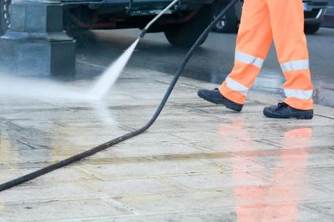 A worker with a pressure washer Фото