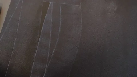 Worker primes a black surface with a roller. white stains on a dark wall Stock Footage 157429176