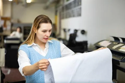 Worker in a printing and press centar check print quality Stock Photos
