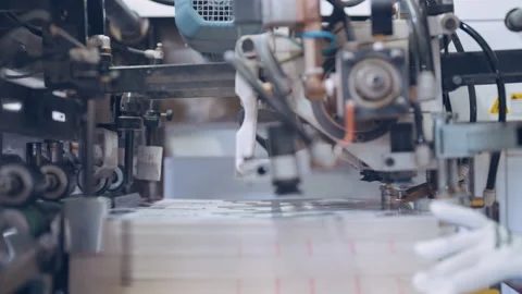 A worker in a printing press prepares printing material. Stock Footage 197463598