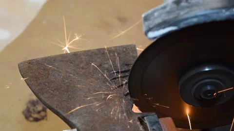 A worker processes a metal part for further alteration. Stock Footage 156340619