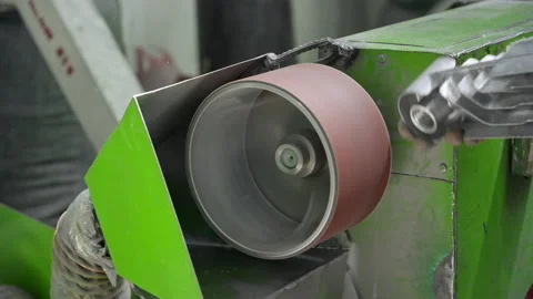 A worker processes a radiator part on a grinding machine, removes burrs after Video stock 205900703