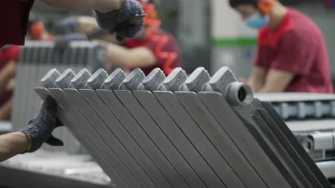The worker processes the radiator part, removes the burr after casting, prepares Stock Footage 200805295