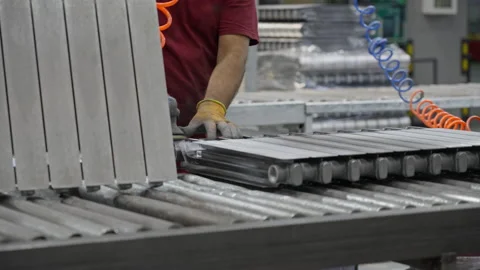 The worker processes the radiator part, removes burrs after casting, prepares it Stock Footage 205892829