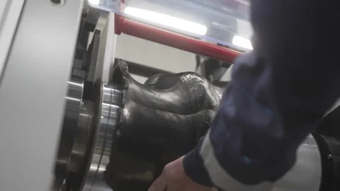 Worker processes recycled rubber mounted on rotating shaft Видео 324070538