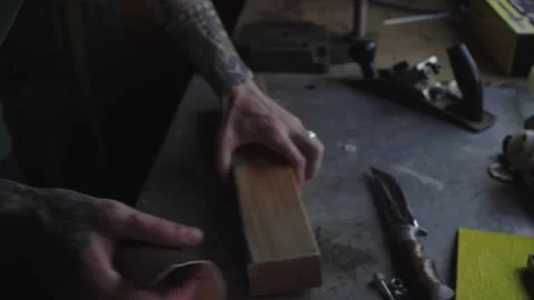 A worker processes wood with sandpaper Video stock 137978474