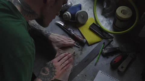 A worker processes wood with sandpaper Video stock 137978493