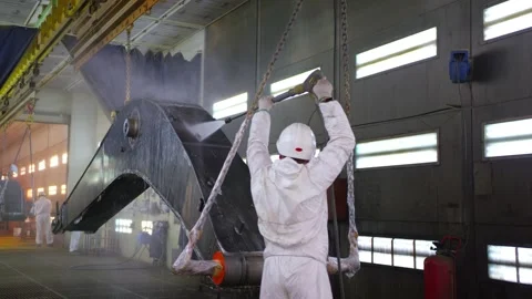 A worker is processing a metal part at the factory with an anticorrosive liquid Stock Footage 163296232