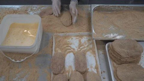 Worker produces schnitzels  in meat processing factory Stock Footage 124311310