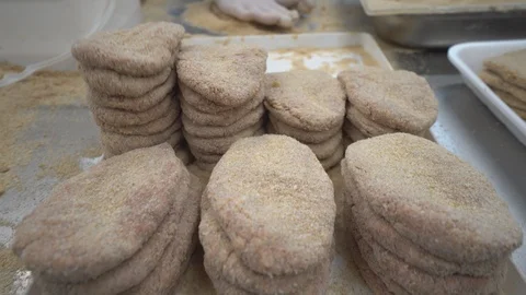 Worker produces schnitzels  in meat processing factory Stock Footage 124319301