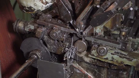 A worker in a production workshop changes steel billet in a machine. An engineer Stock Footage 117329805