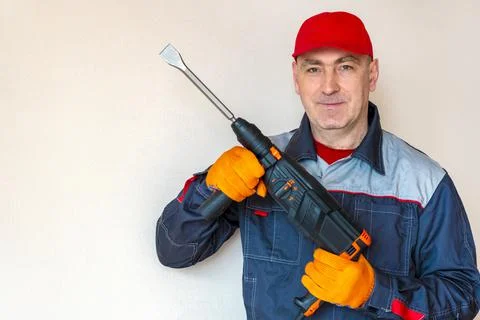 Worker, professional with hammer drill, perforator Stock Photos