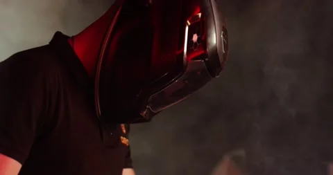 A worker in a professional helmet welds metal parts. We see reflections of light Video stock 166345294