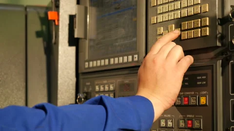 Worker programming and setting up cnc machine with control panel in factory 스톡 동영상 120064293