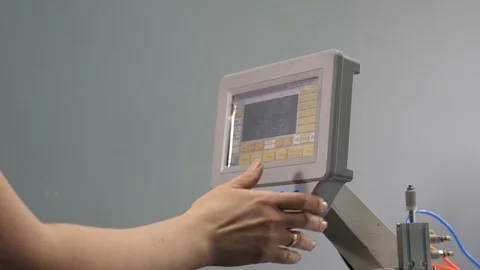 Worker is programming a sewing machine with a CNC using a tablet computer. The 库存影片 119607857